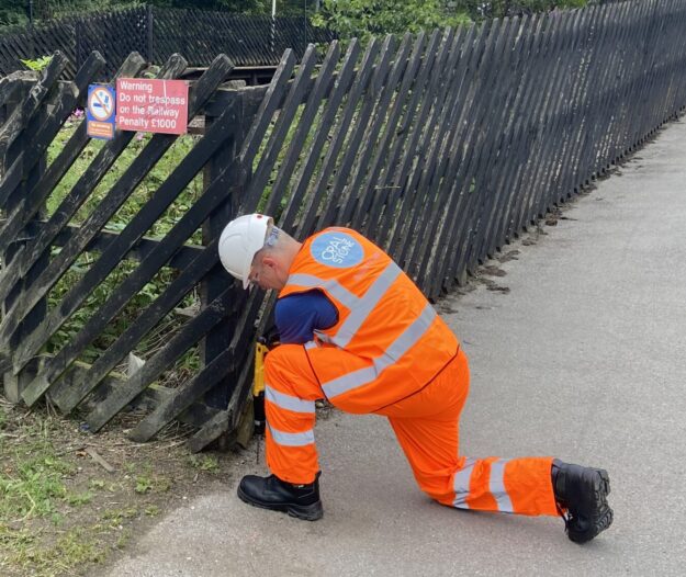 Opalstone employee working on a fence